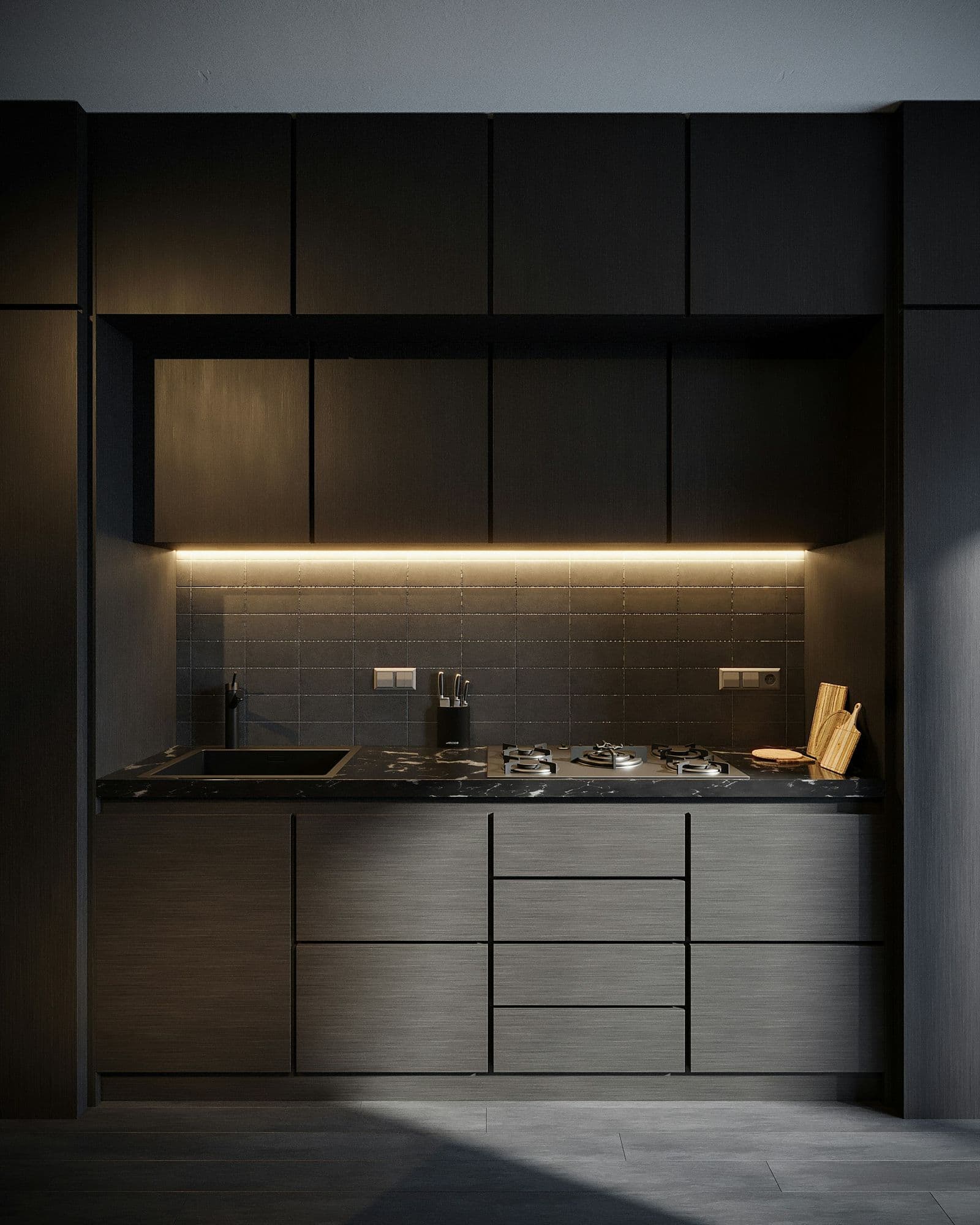Cozinha planejada em tons escuros com iluminação embutida sob os armários